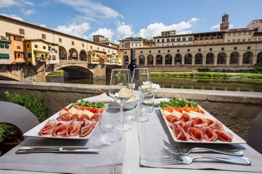 Dinner table with Tuscan dishes and red wine in a restaurant in Florence